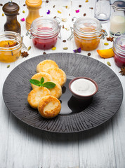 Cottage cheese pancakes with jam and yogurt, selective focus.