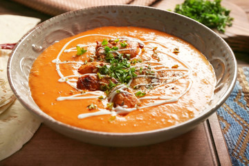 Plate with delicious Murgh Makhani on table