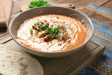 Plate with delicious Murgh Makhani on table
