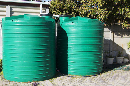 water catchment plastic tanks setup backyard pipes