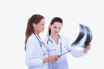 Two woman nurse watching X Ray image, standing in hospital