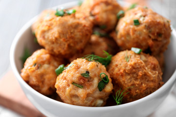Bowl with delicious turkey meatballs on table, closeup