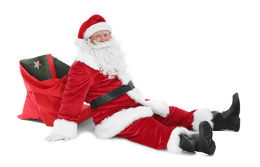 Happy authentic Santa Claus sitting against white background