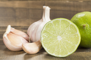 Garlic and lemon on the wooden background