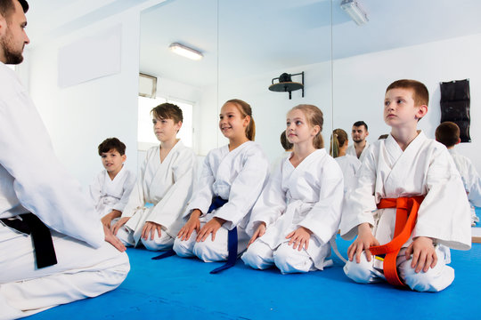 Children enjoying their trainings with coach at karate