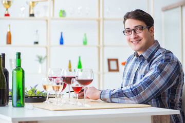 Professional sommelier tasting red wine 