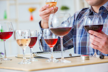 Professional sommelier tasting red wine 