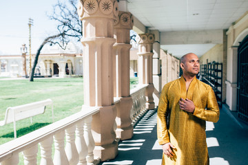 Handsom Indian Man in Gold Kurta at the Temple