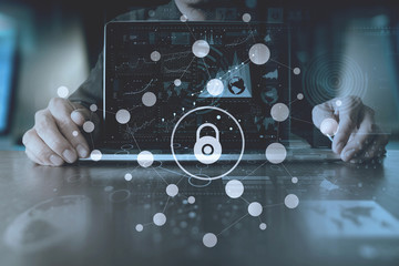 cyber security internet and networking concept.Businessman hand working with VR screen padlock icon on computer background