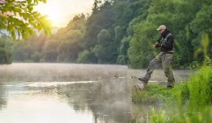 Foto op Aluminium Sport fisherman hunting fish. Outdoor fishing in river © Jag_cz