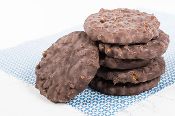 Stack of chocolate nut cookies on raw material