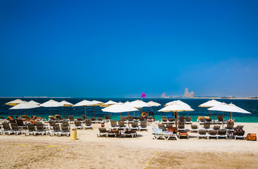 Dubai. Heavenly oasis in Ras al Khaimah. The beach with sunbeds and sunshades in Dubai, on the...