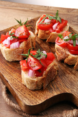 Bruschetta with tomatoes, herbs and oil on toasted garlic cheese bread toasted with chopped tomatoe