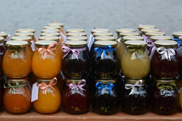 Traditional homemade marmalade. Jam in the glass. Sales of jams at the market.