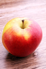 Ripe red apples on wooden background summer concept