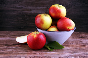 Ripe red apples on wooden background summer concept