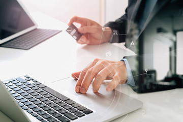 businessman making credit card purchase online with laptop computer on modern desk