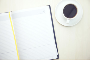 Fototapeta na wymiar Notepad with cup of coffee