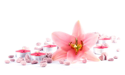 Beauty still life with lily flower, candles and stones isolated on white background