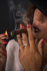 Portrait of sexy elegant lady woman with hat smoking cigar