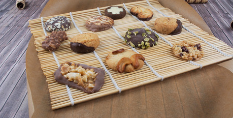 Dark vintage background with various homemade cookies.