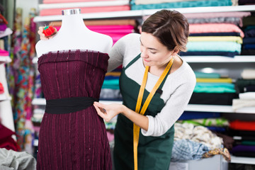 Tailor working at dress