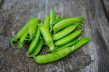pea pods on wooden surface