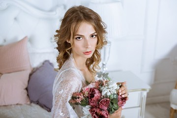 Fashionable female portrait of cute lady in white robe indoors