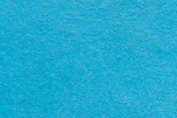 Fototapeta na wymiar Cracked blue paint on a wooden base.