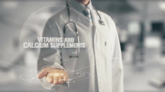 Doctor holding in hand Vitamins and Calcium Supplements