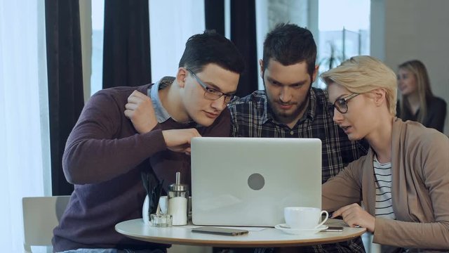 Meeting of co-workers and planning next steps of work with laptop