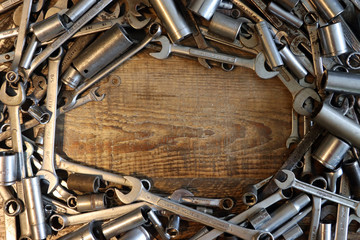 Wrenches and Sockets on Rustic Table Background 