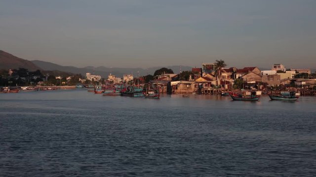 Vietnamese wooden fishing boats on the cai river used as a harbour, riverside time lapse high definition clip.