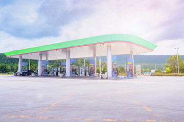 Fototapeta na wymiar Gas fuel station with clouds in the sky and sun light