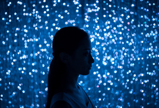 a girl before many lights in the night