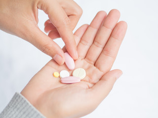 Closeup woman hand holding a pill. Healthcare, medical supplements concept