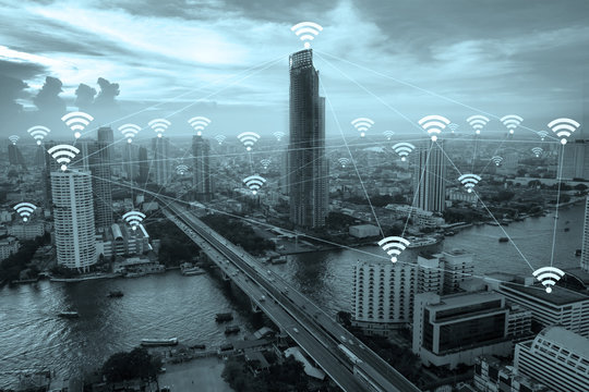 Wifi network connection concept above cityscape background.