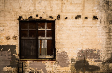 Abstract: Boarded-Up Window in a Dilapidated Warehouse