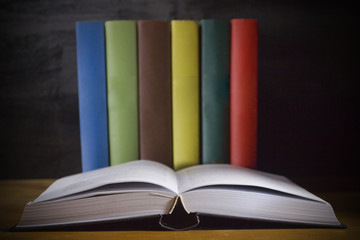 Open book and colorful books