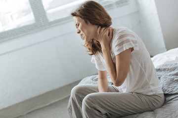 Sad depressed woman suffering from neck inflammation