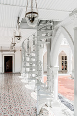 Scenic white spiral staircase at gallery of colonial building