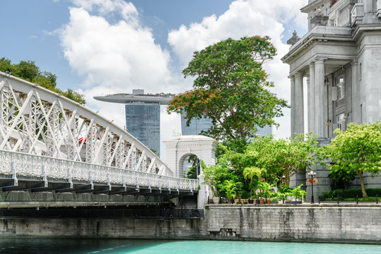 Old colonial building and white bridge over the Singapore River