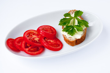 Sandwich with parsley and sliced tomatoes on a white background