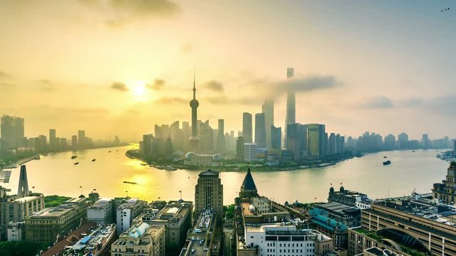 4K Zoom in time-lapse: China,Shanghai skyline at sunrise.Aerial view of high-rise buildings with Huangpu River in Shanghai.