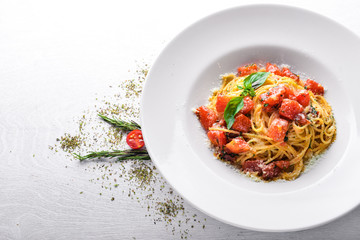Pasta tomatoes. Italian traditional food. On a wooden background. Top view. Free space for your text.