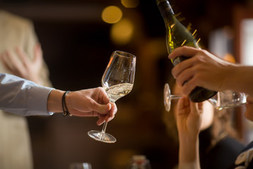 Crop people drinking champagne