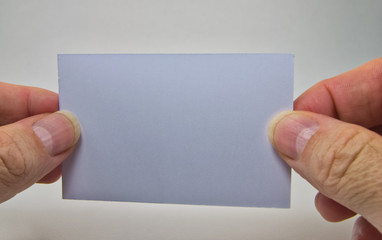 man hand holding a gray empty billboard on a white background