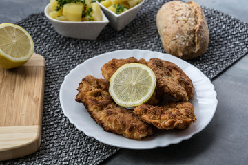 Pork schnitzel with lemon and diced potatoes