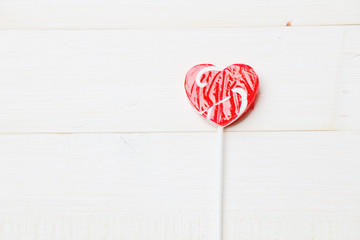 Heart shape lollipop on white background
