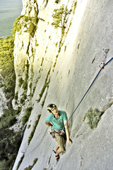 Rock climber reaching for his next hand hold, Joshua Tree National Park.